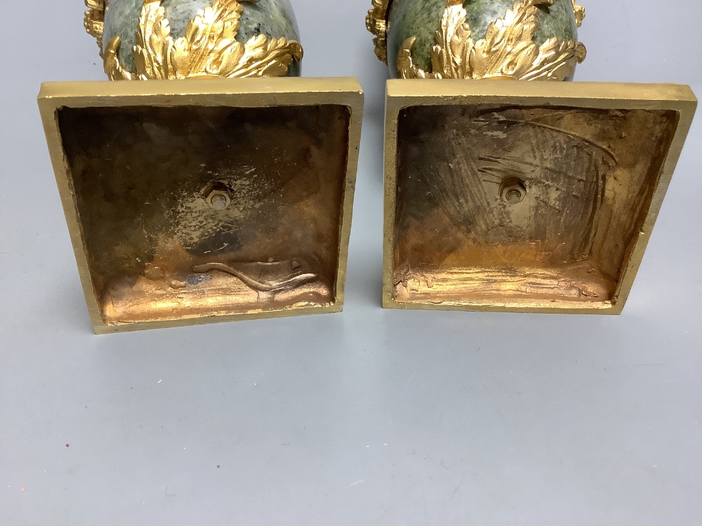 A modern pair of gilt metal and marble urns 32cm